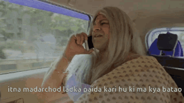 a woman in a wig is talking on a cell phone