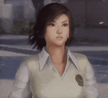 a girl in a white shirt and vest with a badge on her chest looks at the camera