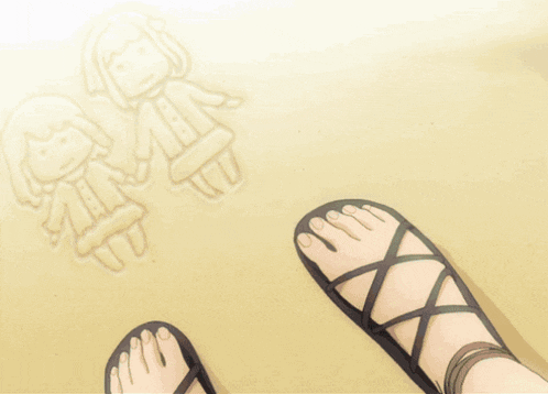a person 's feet in sandals on the beach