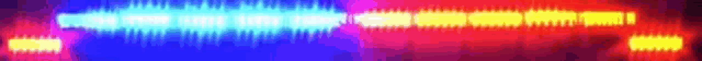 a blue , red , and yellow light is shining on a black background .