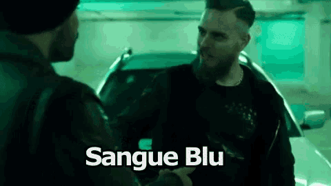 two men are shaking hands in front of a car and the words sangue blu are on the bottom of the image .