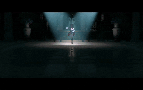 a woman in a red dress is dancing on a stage in a dark room