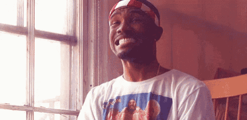 a man wearing a t-shirt with a picture of jesus on it is smiling