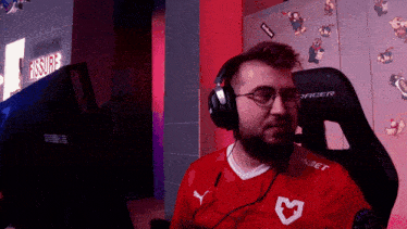 a man wearing headphones and a red shirt that says bwin on it