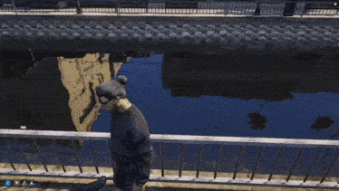 a screenshot of a video game shows a person sitting on a bench near a river