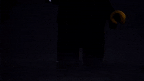 a lego figure in a suit and tie holding a gun