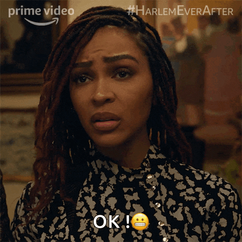 a woman with dreadlocks says ok and has a smiley face on her face