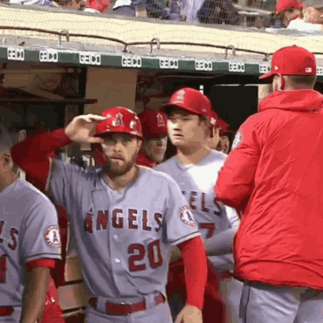 a group of angels baseball players standing in the dugout