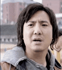 a close up of a man 's face with a serious expression .