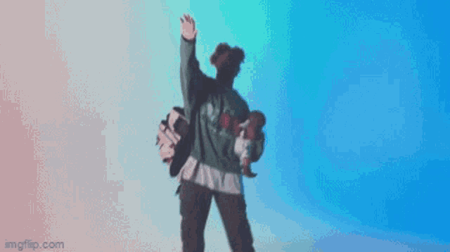 a person is dancing in front of a blue background