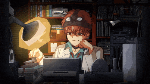 a man in a lab coat and goggles is sitting in front of a computer