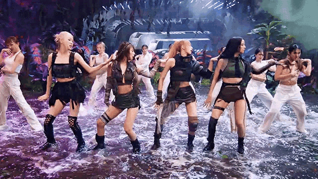 a group of young women are dancing in the water
