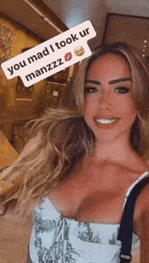 a woman is taking a picture of herself with a caption that says you mad i took ur manzzz