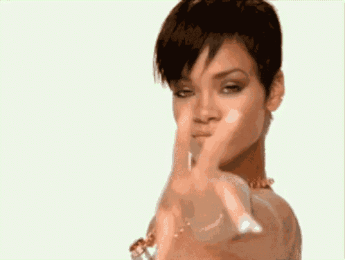a woman is pointing her finger at the camera .