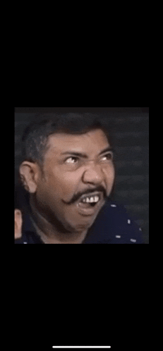 a man with a mustache is making a funny face while looking up .
