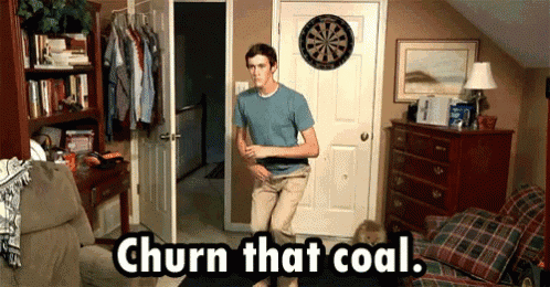 a man standing in front of a dart board with the words churn that coal written below him