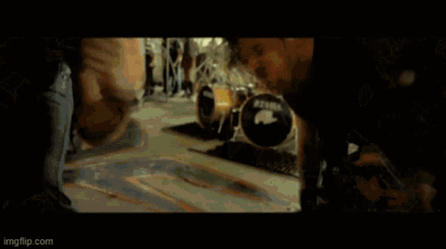 a blurry image of a man singing into a microphone with imgflip.com at the bottom