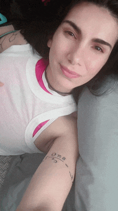 a woman with a tattoo on her arm that says ok8 on it