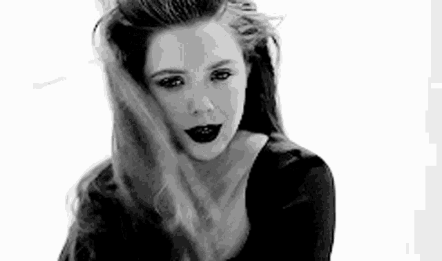 a black and white photo of a woman with long hair .