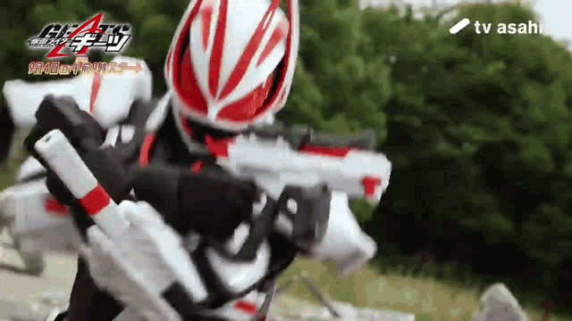 a person in a red white and black costume is holding a gun