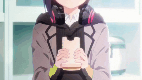 a girl wearing headphones is holding a piece of bread in her hands