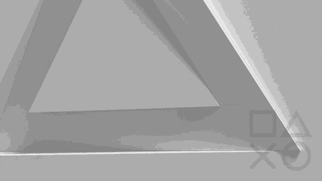 a gray triangle with a square and a x on the bottom