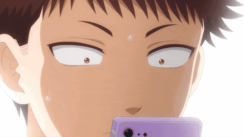 a close up of a person looking at a cell phone with a surprised look on their face
