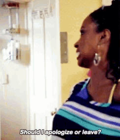 a woman says should i apologize or leave while standing in front of a door