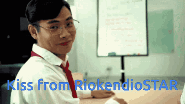 a man sitting at a desk with the words kiss from riokendiostar