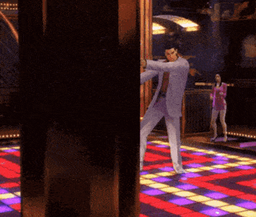 a man in a suit is dancing on a dance floor while a woman in a pink dress looks on .