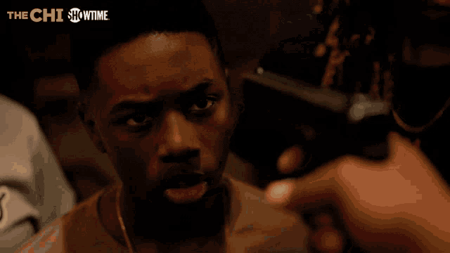 a showtime ad for the chi shows a man holding a gun