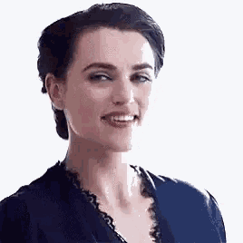 a close up of a woman 's face with a blue shirt on .