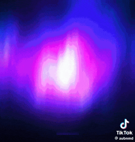 a purple and blue background with a glowing object in the middle