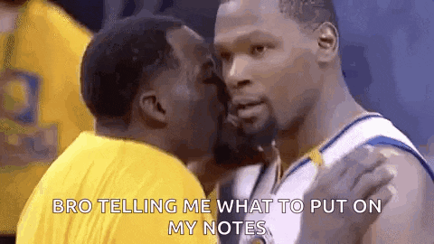 a basketball player is kissing another player on the cheek while talking to him .