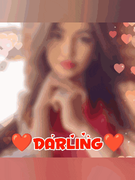 a woman making a heart shape with her hands and the word darling in red
