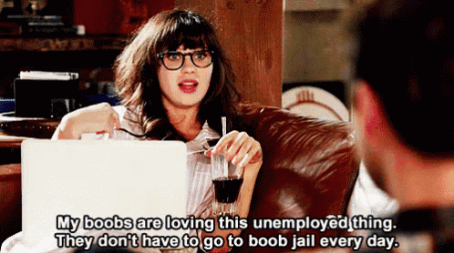 a woman is sitting on a couch holding a glass of wine and a laptop while talking to a man ..