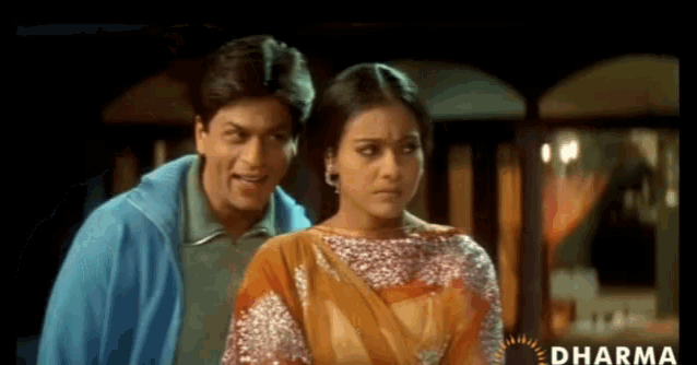 a man and a woman are standing next to each other with dharma written on the bottom of the screen