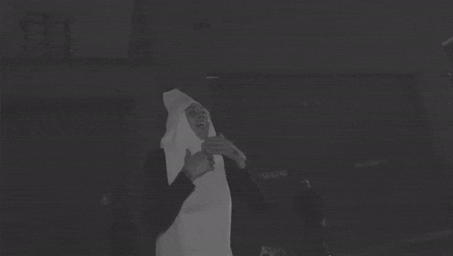 a black and white photo of a person in a white costume
