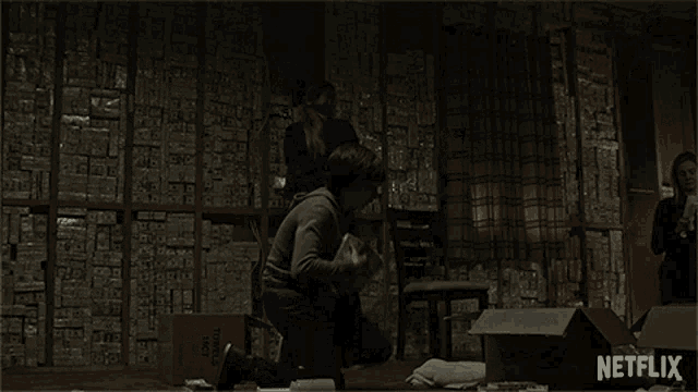 a netflix ad shows a man and two children in a room filled with boxes