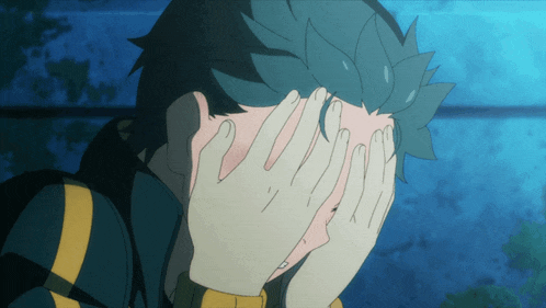 a person covering their face with their hands with a blue background