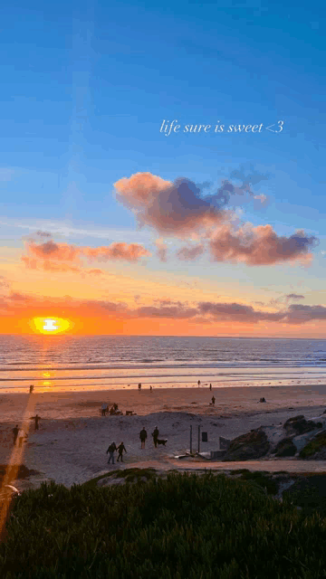 a sunset on a beach with the words life sure is sweet < 3