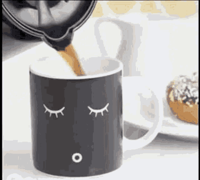a cup of coffee is being poured into a mug with closed eyes .