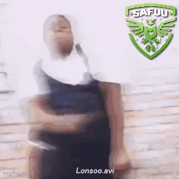 a blurry picture of a woman holding a microphone in front of a safuu logo .