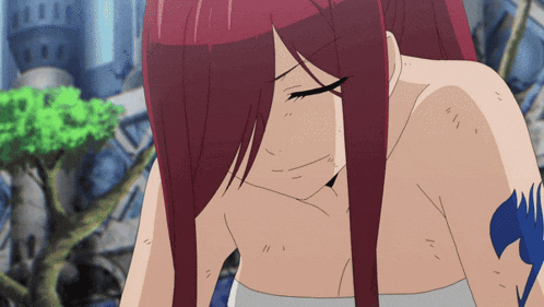 a woman with red hair has a tattoo on her arm