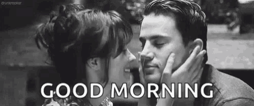 a black and white photo of a man and woman kissing with the words `` good morning '' .