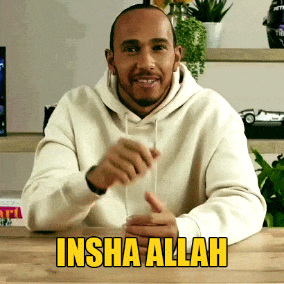 a man in a white hoodie is sitting at a table with the words insha allah above him
