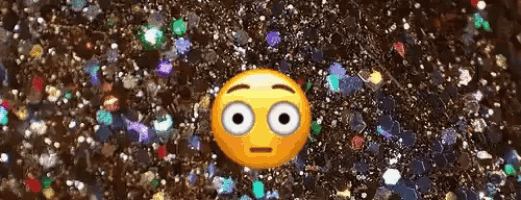 a yellow smiley face with white eyes is surrounded by glitter .