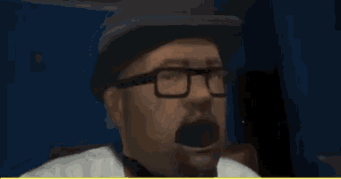 a man wearing glasses and a hat has his mouth open