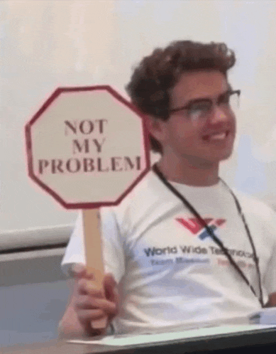 a man holds a sign that says not my problem