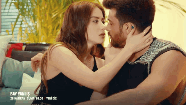 a man and a woman are kissing in front of a sign that says bay yanlis 26 haziran cuma 20.00 yeni dizi